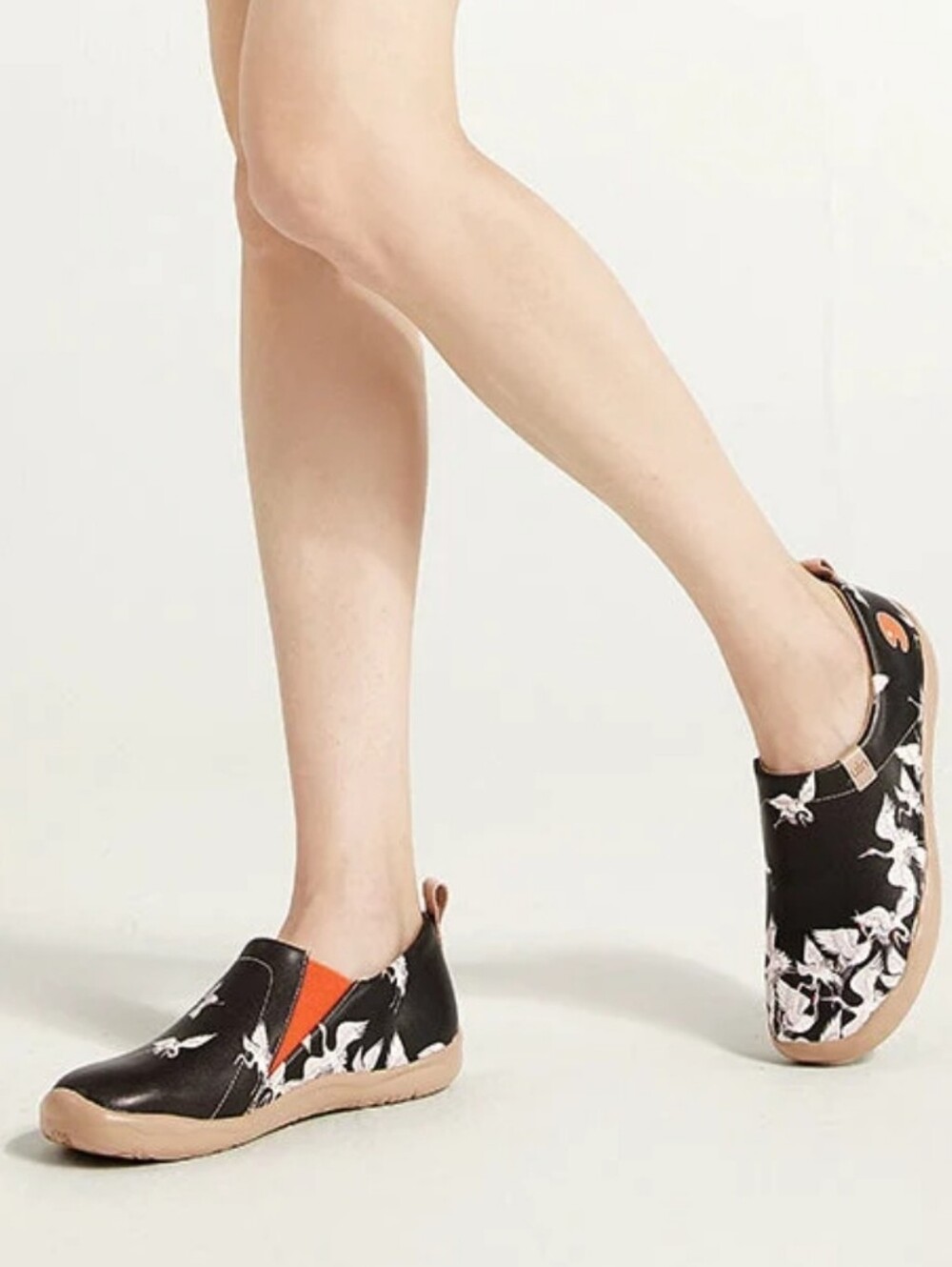 UIN Black Floral Slip-Ons with Orange Accents and Beige Soles